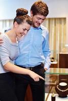 happy young couple in jewelry store photo