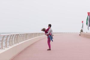 mother and cute little girl on the promenade by the sea photo