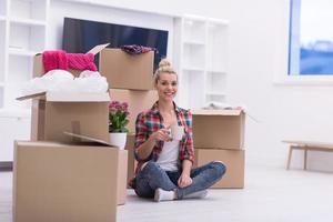 woman with many cardboard boxes sitting on floor photo