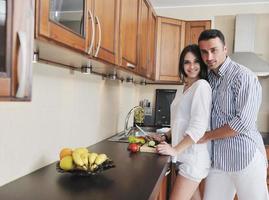 happy young couple have fun in modern kitchen photo