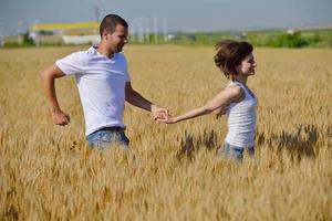 happy couple in wheat field photo