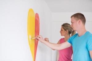 couple are painting a heart on the wall photo