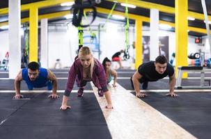 young healthy people doing pushups photo