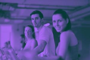 Group of people running on treadmills photo