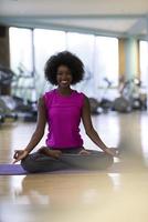 african american woman exercise yoga in gym photo