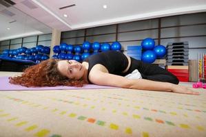 pretty girl warming up in fitness studio photo