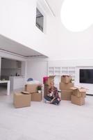 woman with many cardboard boxes sitting on floor photo