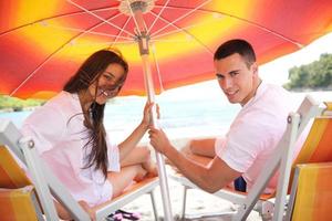 happy couple have fun on the beach photo