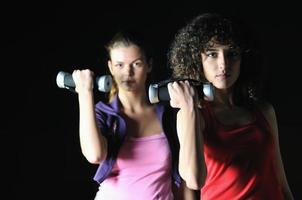 two women work out  in fitness club photo