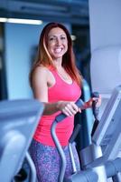 woman exercising on treadmill in gym photo