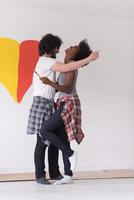 couple with painted heart on wall photo