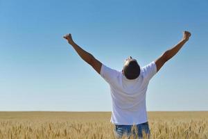 man in wheat field photo