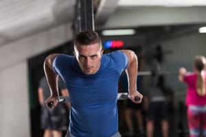 man doing exercises parallel bars photo