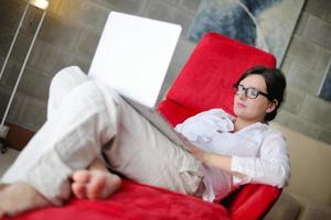 woman using a laptop computer at home photo