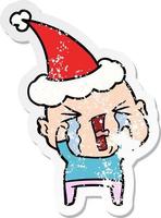 distressed sticker cartoon of a crying bald man wearing santa hat vector