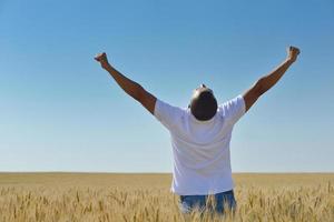 man in wheat field photo