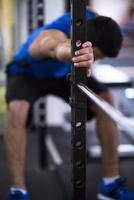 man doing pull ups on the vertical bar photo