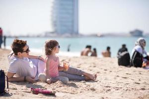 Mom and daughter on the beach photo