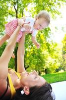woman and baby have playing at park photo
