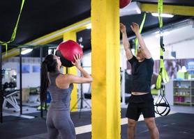 young athletes couple working out with medical ball photo