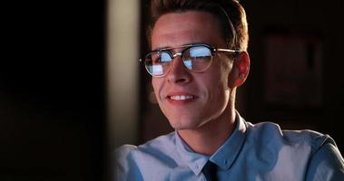 man working on computer in dark office photo