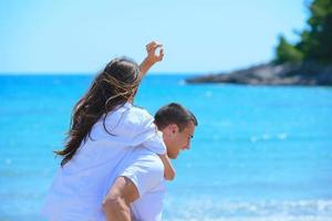 happy couple have fun on the beach photo