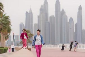 mother and cute little girl on the promenade photo