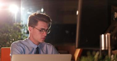 man working on computer in dark office photo