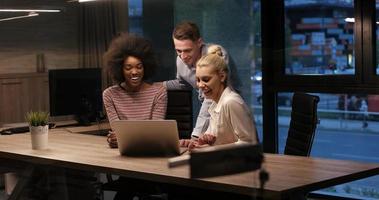 Multiethnic startup business team in night office photo