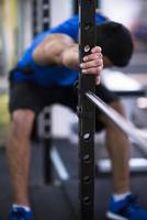 man doing pull ups on the vertical bar photo