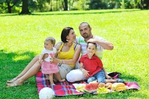 happy young couple with their children have fun at park photo