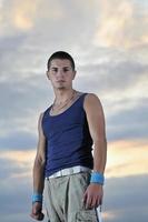 young man dancing and jumping  on top of the building photo