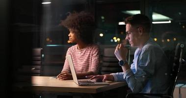 Multiethnic startup business team in night office photo