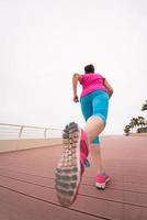 woman busy running on the promenade photo