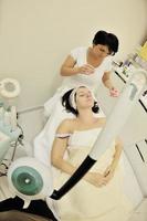 woman with facial mask in cosmetic studio photo