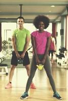 couple  workout with weights at  crossfit gym photo