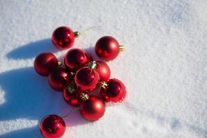 red christmas ball in fresh snow photo