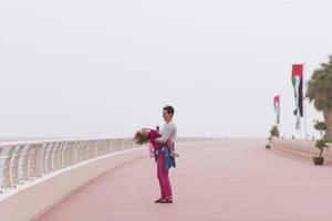 mother and cute little girl on the promenade by the sea photo