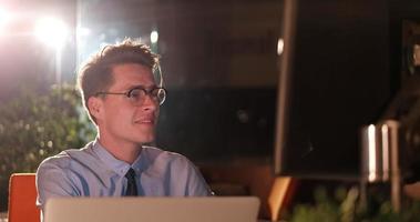 man working on computer in dark office photo