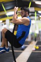 man doing rope climbing photo