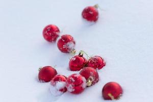 red christmas balls in fresh snow photo