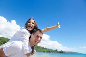 happy couple have fun on the beach photo