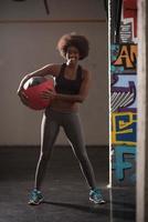 black woman carrying crossfit ball photo