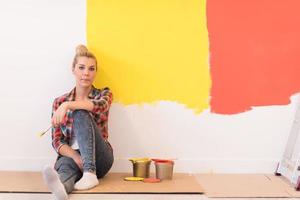 young female painter sitting on floor photo