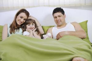 happy family relaxing in bed photo