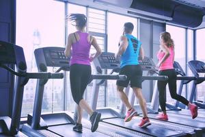 Group of people running on treadmills photo