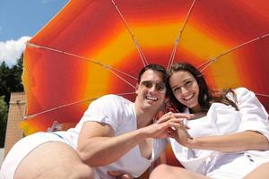 happy couple have fun on the beach photo