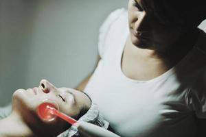 woman with facial mask in cosmetic studio photo