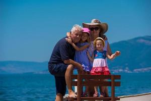 portrait of grandparents and granddaughters by the sea photo