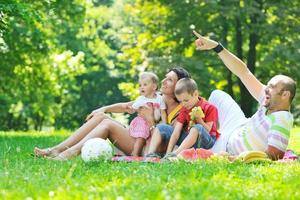 happy young couple with their children have fun at park photo